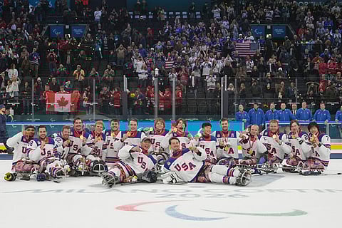 Players of the United States celebrate on the podium after winning the gold medal at the ice hockey of the 2026 Winter Paralympics, in Milan, Italy