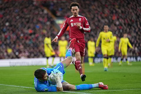Tottenham's goalkeeper Guglielmo Vicario catches the ball during the Premier League soccer match between Liverpool and Tottenham in Liverpool, England.