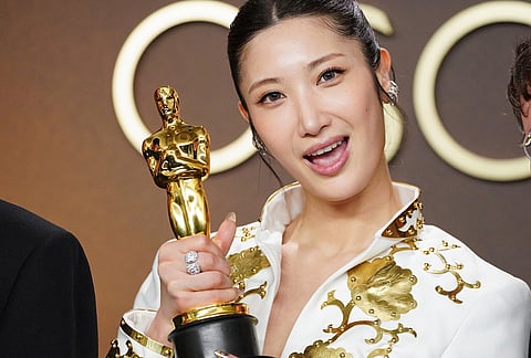 EJAE, winner of the award for music (original song) for "Golden" from "K-pop Demon Hunters," poses in the press room at the Oscars at the Dolby Theatre in Los Angeles. 