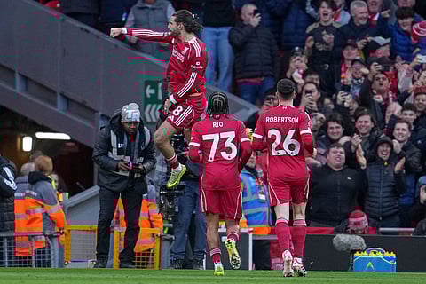 Liverpool's Dominik Szoboszlai celebrates after scoring during the Premier League soccer match between Liverpool and Tottenham in Liverpool, England.