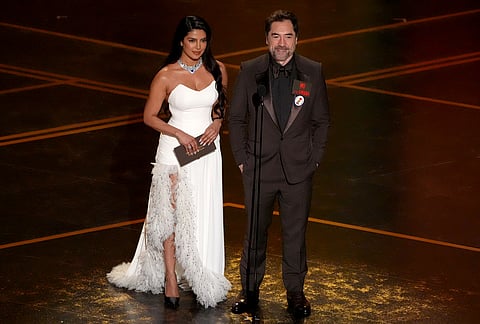 Priyanka Chopra Jonas, left, and Javier Bardem present the award for best international feature film during the Oscars at the Dolby Theatre in Los Angeles. 