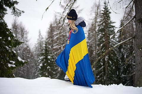 Ebba Aarsjoe, of Sweden, poses for photos with her alpine skiing three gold and one bronze medals, at the 2026 Winter Paralympics, in Cortina d'Ampezzo, Italy.