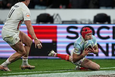 Louis Bielle‑Biarrey of France scores a try during the Six Nations rugby union match between France and England in Saint-Denis, outside Paris.