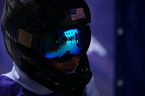 Anna Soens, of the United States, watches Mata Rodriguez, of Spain, reflected in her goggles, leave the start gate for her second run in the alpine skiing women's giant slalom sitting at the 2026 Winter Paralympics, in Cortina d'Ampezzo, Italy.