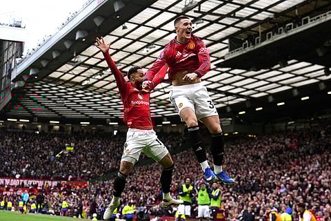 Manchester United's Benjamin Sesko, right, celebrates scoring their side's third goal of the game with team-mate Matheus Cunha during the Premier League match between Manchester United and Aston Villa, in Manchester, England.