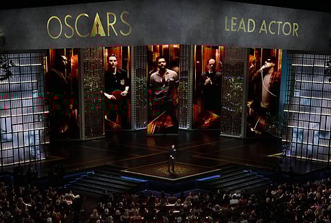Adrien Brody presents the award for best performance by an actor in a leading role during the Oscars at the Dolby Theatre in Los Angeles.