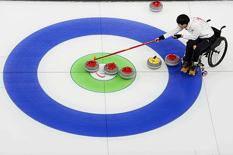 Jinqiao Yang, of China, competes during wheelchair curling mixed doubles round robin session against Italy at the 2026 Winter Paralympics, in Cortina d'Ampezzo, Italy.