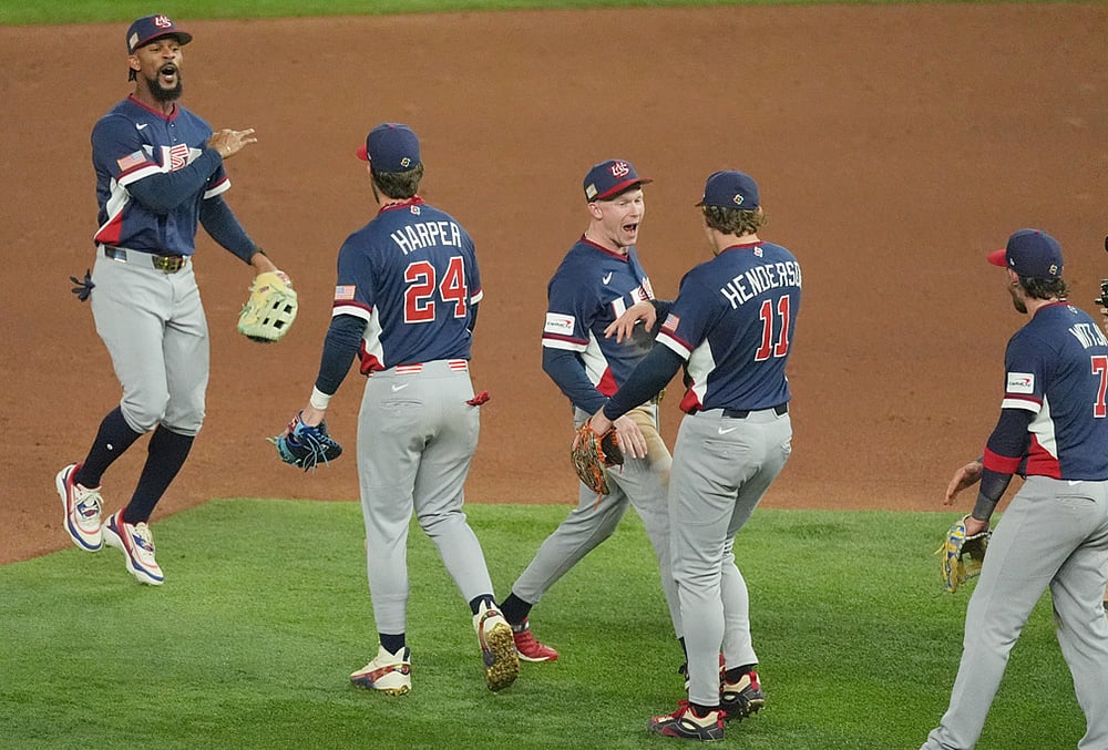 The United States team celebrates after defeating the Dominican Republic at a World Baseball Classic semifinal game in Miami.  - | Photo: AP/Rebecca Blackwell