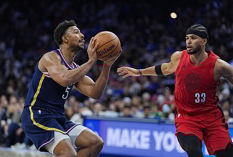 Philadelphia 76ers' Quentin Grimes (5) goes up to shoot against Portland Trail Blazers' Toumani Camara during the second half of an NBA basketball game, in Philadelphia.
