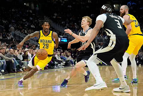 Indiana Pacers' Quenton Jackson (29) dribbles against Milwaukee Bucks' AJ Green during the first half of an NBA basketball game, in Milwaukee. 