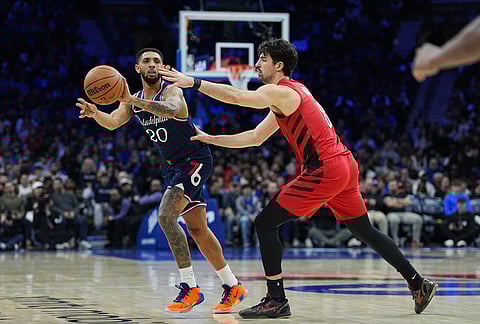 Philadelphia 76ers' Cameron Payne (20) passes past Portland Trail Blazers' Deni Avdija during the second half of an NBA basketball game in Philadelphia.