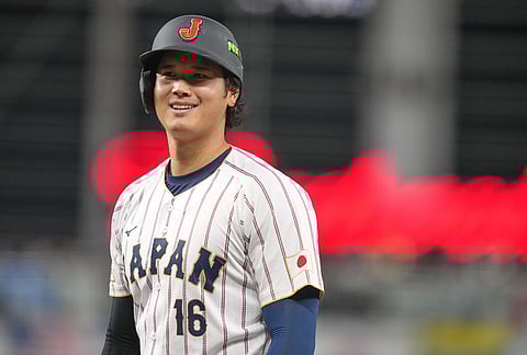Japan's Shohei Ohtani smiles after is intentionally walked during the third inning of a World Baseball Classic quarterfinal game against Venezuela in Miami.