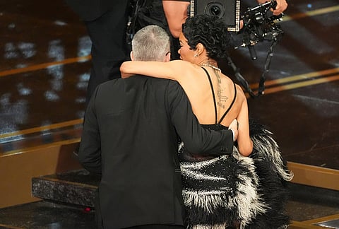 Paul Thomas Anderson, left, and Teyana Taylor celebrate "One Battle After Another" best picture win during the Oscars  at the Dolby Theatre in Los Angeles. 