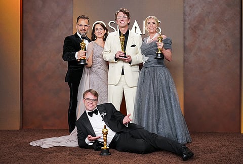 Pavel Talankin, front center, and Radovan Sibrt, top left, Alzbeta Karaskova, David Borenstein, and Helle Faber, winners of the award for documentary feature film for "Mr. Nobody against Putin," pose in the press room at the Oscars at the Dolby Theatre in Los Angeles. 