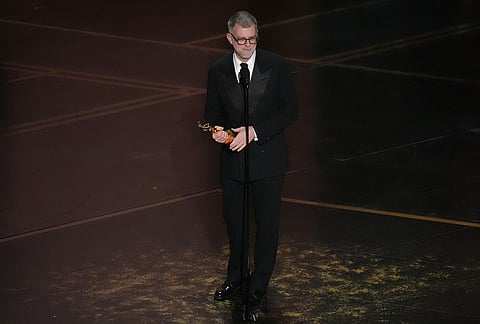 Paul Thomas Anderson accepts the award for directing for "One Battle After Another" during the Oscars at the Dolby Theatre in Los Angeles.