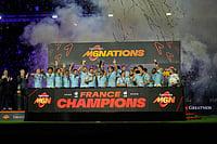 | Photo: AP/Michel Euler : Antoine Dupont of France holds the trophy aloft after clinching the title after winning the Six Nations rugby union match between France and England in Saint-Denis, outside Paris.