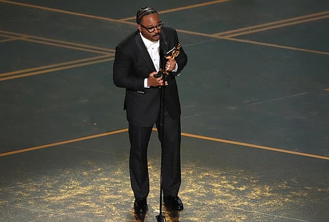 Ryan Coogler accepts the award for writing (original screenplay) for "Sinners" during the Oscars at the Dolby Theatre in Los Angeles.