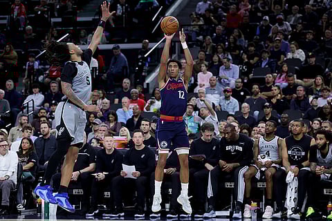 Los Angeles Clippers guard Cam Christie, right, shoots against San Antonio Spurs guard Stephon Castle during the second half of an NBA basketball game in Inglewood, Calif.