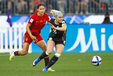 Australia's Ellie Carpenter, right, and China's Chen Qiaozhu, left, battle for the ball during the Women's Asian Cup semifinal soccer match between China and Australia in Perth, Australia.