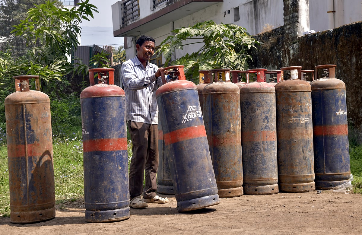 A worker carries LPG cylinders at a distribution centre, in Dehradun, Uttarakhand, Wednesday, March 11, 2026. Long queues were seen at several gas agencies amid an ongoing LPG supply shortage in the country - RAHULGROVER