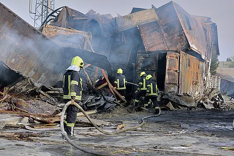 Firefighters work at the site of a late-Monday airstrike at a drug rehabilitation hospital in Kabul, Afghanistan.