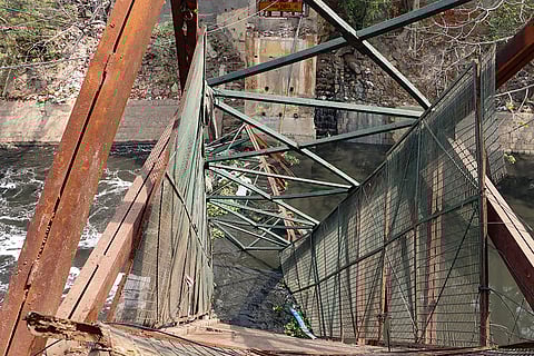 The collapsed foot overbridge where a woman died after falling into the drain beneath, in Roop Nagar, New Delhi.