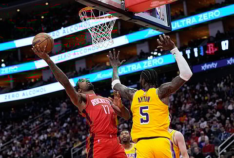 Houston Rockets' Tari Eason (17) goes up for a shot as Los Angeles Lakers' Deandre Ayton (5) defends during the second half of an NBA basketball game in Houston.