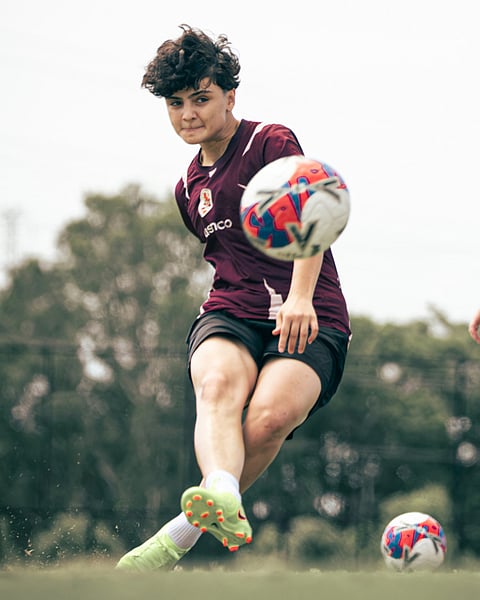 Iranian soccer player Fatemeh Pasandideh kicks a ball at a Brisbane Roar club training session in Brisbane, Australia.