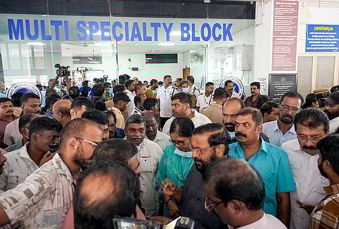 People gather on-site after a fire broke out in a portion of the multi-speciality block of the government medical college, in Thiruvananthapuram, Kerala.