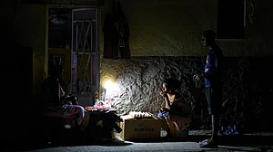 Photo: AP : Street vendors chat during a blackout in Havana, Monday, March 16, 2026.