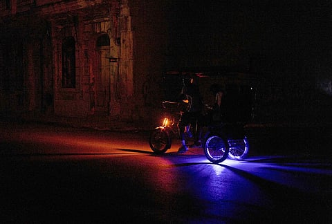 A vehicle drives down a street during a blackout in Havana, Wednesday, March 4, 2026. 