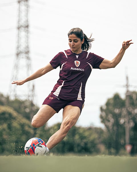 Iranian soccer player Atefeh Ramezanisadeh kicks a ball at a Brisbane Roar club training session in Brisbane, Australia.