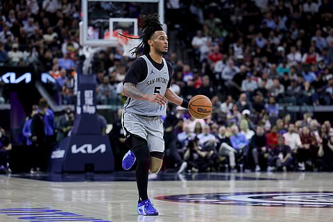 San Antonio Spurs guard Stephon Castle brings the ball upcourt during the first half of an NBA basketball game against the Los Angeles Clippers in Inglewood, Calif.