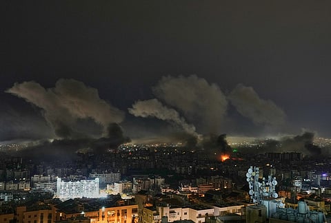 Smoke rises from buildings following an Israeli airstrike in Dahiyeh, Beirut's southern suburbs, Lebanon, Wednesday, March 11, 2026. 