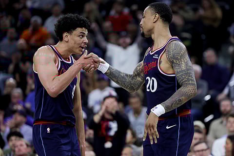 Los Angeles Clippers guard Kobe Sanders, left, reacts with forward John Collins during the second half of an NBA basketball game against the San Antonio Spurs in Inglewood, Calif.