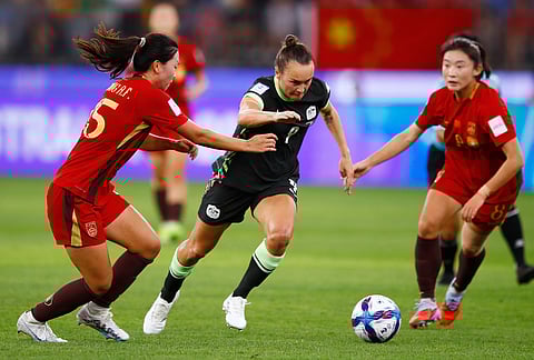Australia's Caitlin Foord, centre, looks to get past China's Wang Aifang, left, during the Women's Asian Cup semifinal soccer match between China and Australia in Perth, Australia.