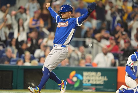 Venezuela Andres Gimenez scores on a single by Ronald Acuña Jr., during the seventh inning of a World Baseball Classic semifinal game against Italy, in Miami.