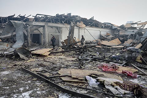 Residents and rescue workers inspect the site of a late-Monday airstrike at a drug rehabilitation hospital in Kabul, Afghanistan.