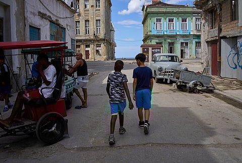 People walk outside during a blackout in Havana, Cuba, Monday, March 16, 2026. 