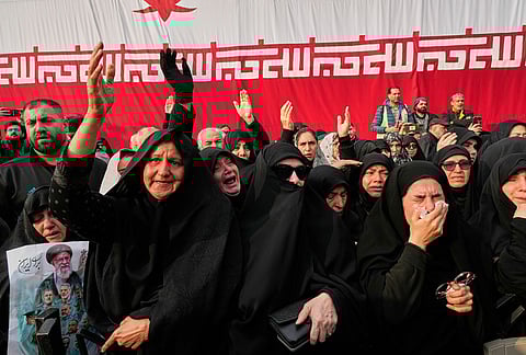 Mourners react during the funeral ceremony for Gen. Ali Shamkhani, secretary of Iran's Defense Council and a senior adviser to the Supreme Leader who was killed in a strike, at the courtyard of the Imamzadeh Saleh shrine in Tehran, Iran, Saturday, March 14, 2026. 