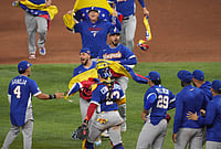 | Photo: AP/Lynne Sladk : The Venezuela team celebrates after defeating Italy at a World Baseball Classic semifinal game in Miami. 