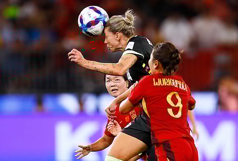 Australia's Alanna Kennedy heads the ball away from China's Wurigumula right, during the Women's Asian Cup semifinal soccer match between China and Australia in Perth, Australia.