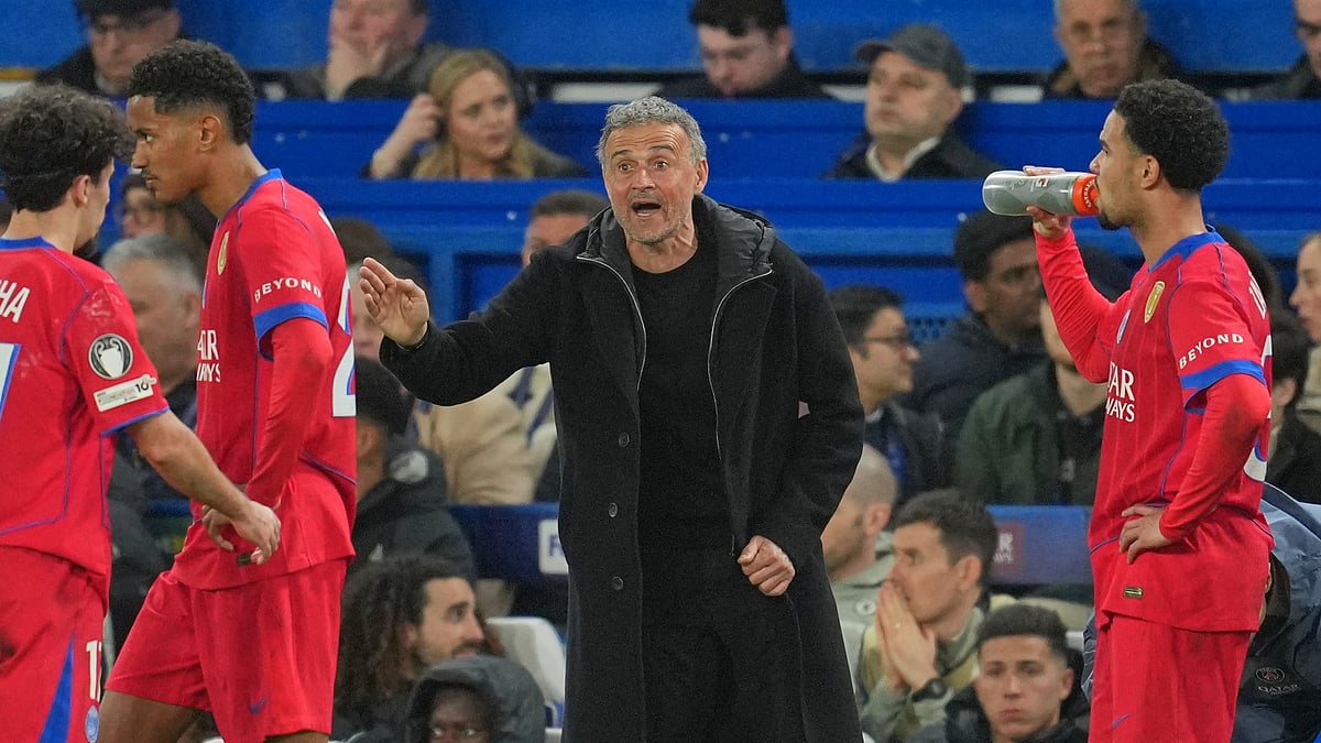 PSG's head coach Luis Enrique talks to his players during the Champions League soccer match. - AP