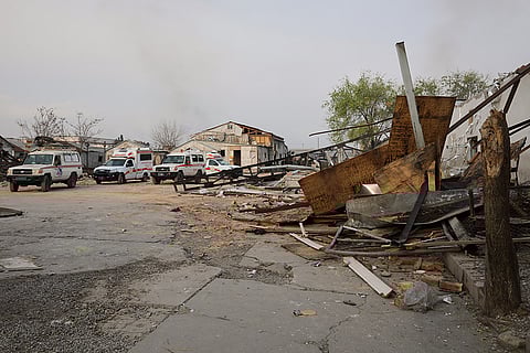 Ambulances and medical vehicles are parked at the site of a late-Monday airstrike at a drug rehabilitation hospital in Kabul, Afghanistan.