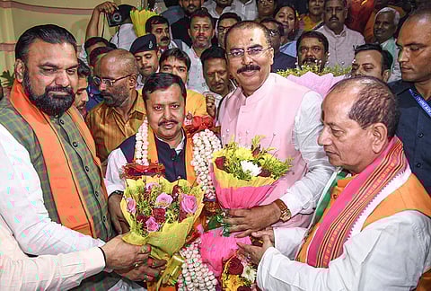 Bihar Deputy Chief Ministers Samrat Chaudhary, left, Vijay Kumar Sinha, right, and others greet BJP President Nitin Nabin after the NDA swept all five Bihar seats in the Rajya Sabha elections, in Patna.
