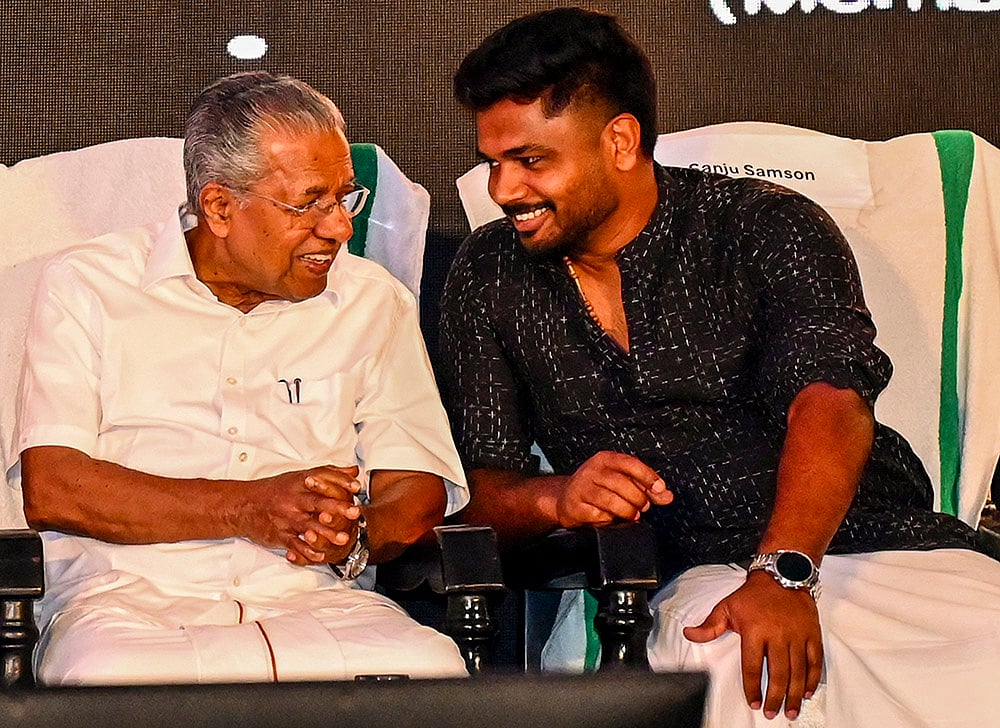 Kerala CM Pinarayi Vijayan with cricketer Sanju Samson