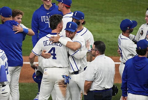 The Italy team console each other after losing to Venezuela at a World Baseball Classic semifinal game in Miami. 