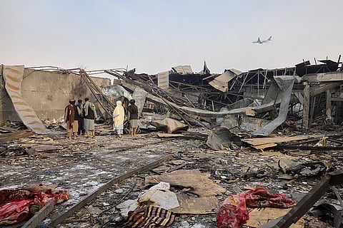 Residents and volunteers inspect the site of a late-Monday airstrike at a drug rehabilitation hospital in Kabul, Afghanistan.