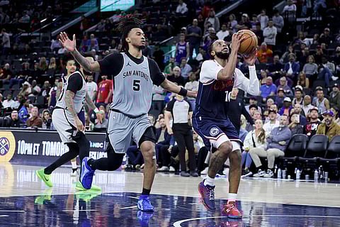 Los Angeles Clippers guard Darius Garland, right, shoots against San Antonio Spurs guard Stephon Castle during the second half of an NBA basketball game in Inglewood, Calif.