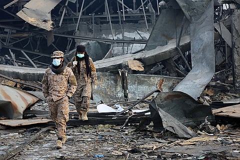 Taliban rescue workers inspect the site of a late-Monday airstrike at a drug rehabilitation hospital in Kabul, Afghanistan.